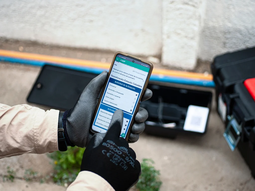 Técnico registrando una inspección de control de roedores en Central MIP desde un teléfono móvil